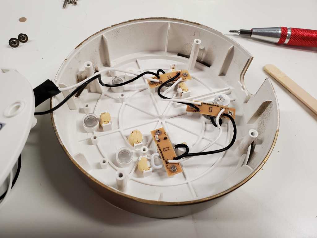 Screwing the LED boards back into the bottom of the case.