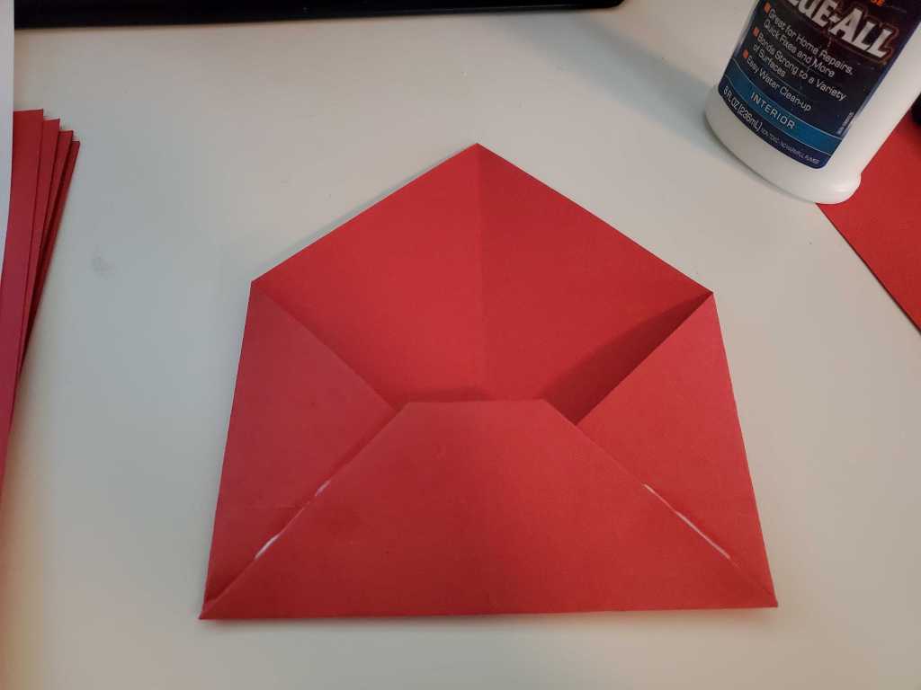 Sealing the envelopes with a little bit of white glue.