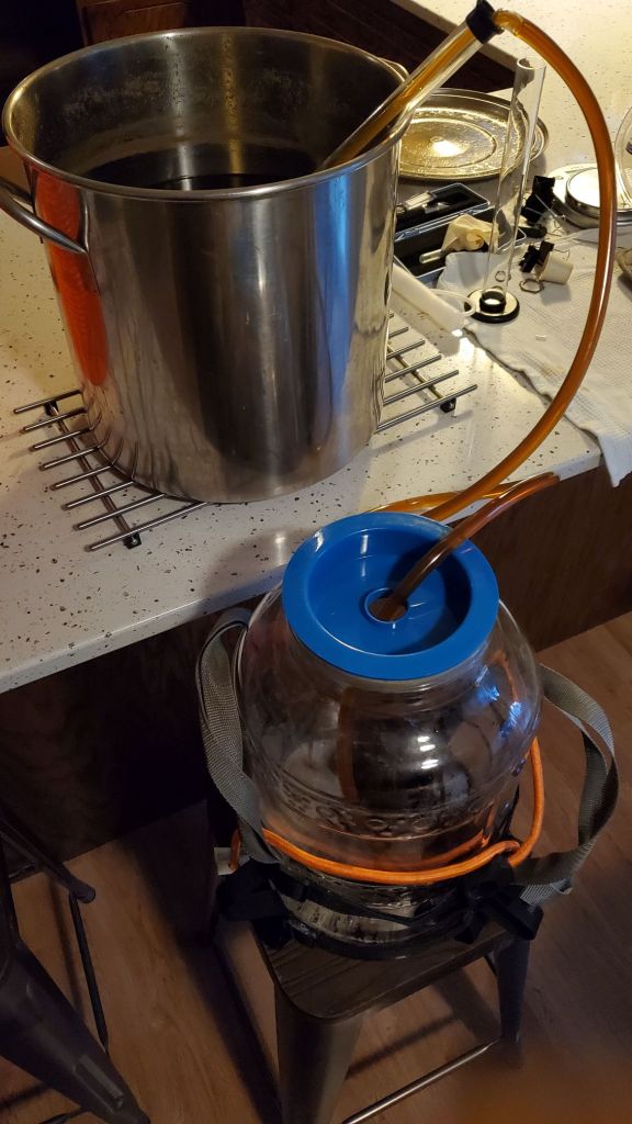 Boiled wort being siphoned into a fermentor.